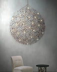 A Germanium LED Wall Paper with Swarovski chandelier hanging above a chair in a room, providing ambient lighting. (Brand: Meystyle)